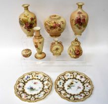 ROYAL WORCESTER; a pair of cabinet plates with painted armorial and floral decoration, by Edward