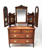 An Edwardian mahogany duchess dressing chest, with triptych mirrors and mirrored cupboard doors,