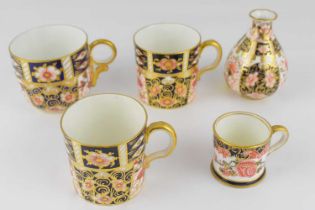 ROYAL CROWN DERBY; two coffee cans and a teacup, height 6cm, in the 2451 Imari pattern, together