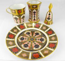 ROYAL CROWN DERBY; four items of 1128 Imari pattern porcelain, comprising a cup, a bell, a six-sided