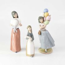 LLADRÓ; three figures of young ladies, comprising one carrying a bunch of balloons, one holding a