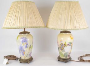 A pair of modern table lamps, the glass bodies of ovoid form, with printed floral design, raised