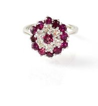 An 18ct white gold cluster ring set with central ruby surrounded by six diamonds, surrounded by