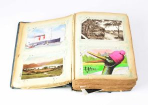 A postcard album with coloured and black and white cards, including topographical portraits,