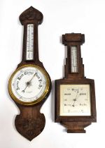 Two early 20th century wall mounted aneroid oak cased wall barometers, one inscribed to the white