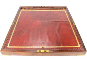 A late 19th/early 20th century rosewood writing slope with brass bound corners, lock and key, red