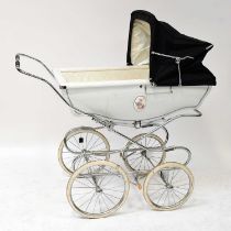 SILVERCROSS; a coach built pram with black hood and white sides, with inset floral panel, label to