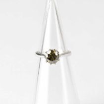 An 18ct white gold solitaire ring set with green diamond, approx. 1ct, in a claw setting, stamped '