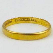 A 22ct gold thin wedding band, size O, approx. 2g.