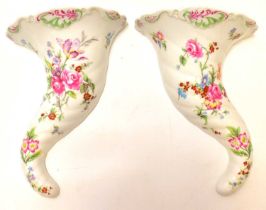 ROYAL WORCESTER; a pair of porcelain floral decorated wall pockets in the form of cornucopias,