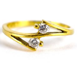 A 14ct gold dress ring with two cross-over white stones, size O, approx. 2.3g.