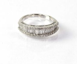 An 18ct white gold half eternity ring set with baguette cut diamonds, surrounded by smaller