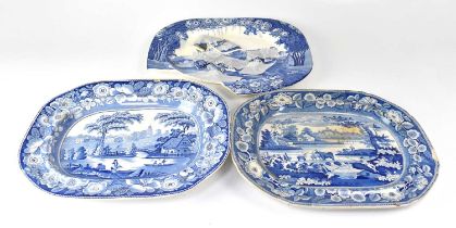 Three blue and white meat plates and two circular blue and white chargers, including a tin glazed