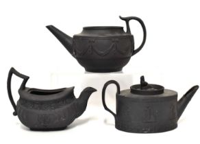 Three 19th century black basalt teapots, to include a lidless Wedgwood example of silver shape,