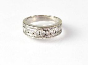 An 18ct white gold diamond set half eternity ring, the nine diamonds set within an upper and lower