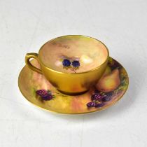 ROYAL WORCESTER; a gilt-heightened hand painted coffee cup and saucer, the cup decorated with apples