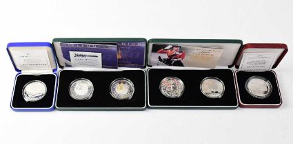 Four cased sets of UK silver proof coins comprising a Jubilee silver crown set 2002, a Millennium