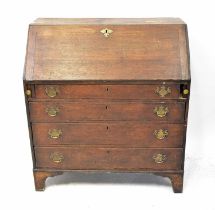 A George III oak bureau with four long graduated drawers beneath a slope, on bracket feet, 101 x