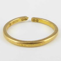 A 22ct yellow gold thin wedding band, size N, approx. 2.4g. Condition Report: The ring has been