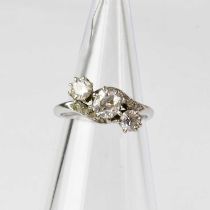 An 18ct white gold three-stone diamond ring, the central diamond approx. 0.5ct, flanked by two