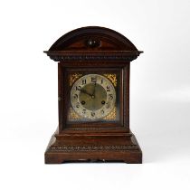 WOOD BROS; an early 20th century oak cased twin drum movement mantel clock, the arched pediment