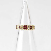 An 18ct gold ring set with alternating rubies and diamonds, stamped '18K DIA', size K1/2, approx.