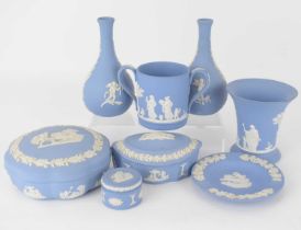 WEDGWOOD; eight items of blue jasperware pottery, to include a pair of small vases, height 14cm, a
