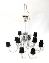 A very large chrome electrolier with thirteen scrolling branches, each terminating in a black silk