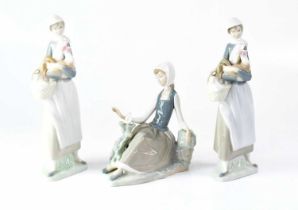 LLADRÓ; a pair of figure groups of a young lady holding a basket and a chicken and a further