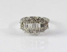 An 18ct white gold diamond cluster ring, with five graduated baguette cut stones, within a border of