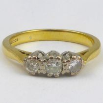 An 18ct three-stone diamond ring, one stone 0.1ct, two stones 0.07ct, size P, approx. 4g.