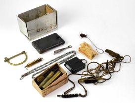 A WWII period German cased rifle cleaning kit, with pull-through and brushes, also a further metal