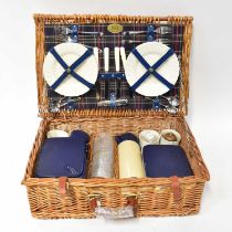 A Harrods wicker picnic basket containing a quantity of Optima tupperware.
