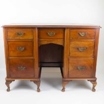 A Victorian mahogany kneehole desk, with small central drawer flanked by two banks of three