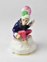 A 19th century Staffordshire inkwell in the form of a monkey wearing a feathered turban and