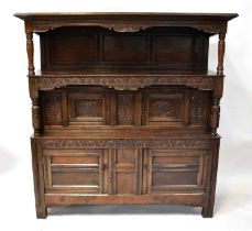 An early 18th century Welsh oak cwpwrdd tridarn with upper shelf above middle section, with pair