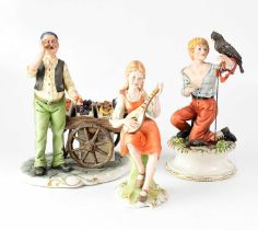 CAPODIMONTE; three figures, comprising a market stall vendor with his wagon of fruit, a boy with a