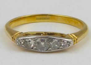 An 18ct gold diamond ring, the platinum mount with five graduated brilliant cut diamonds, size Q,