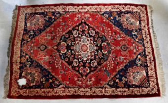 A Turkmenistan Meshed hand knotted red ground rug, 200 x 140cm (af). Condition Report: There is a