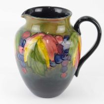 WILLIAM MOORCROFT; a tall jug with tube-lined grape and leaf pattern, height 21cm, with signature