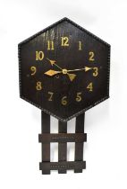 An early 20th century American oak slat clock, the hexagonal dial with beaded rim and applied