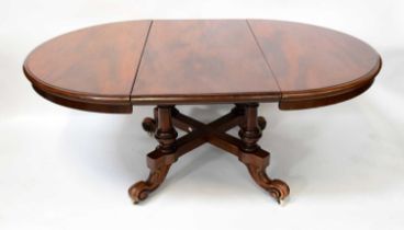 A Victorian mahogany circular extending table with single additional leaf, raised on four turned