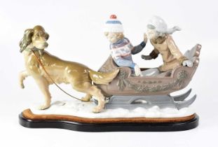 LLADRÓ; a figure group 'Sleigh Ride', depicting children being pulled in a sleigh by a dog, on a