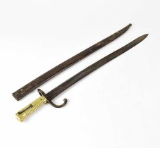 A 19th century French chassepot bayonet with brass handle and hooked quillon, stamped to the gilt