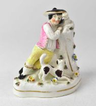 LLOYD SHELTON; a Staffordshire figure of a shepherd modelled reclining against a bough, with a dog