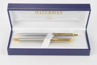 WATERMANS; a cased ballpoint pen presentation set, in a gold and brushed stainless finish,