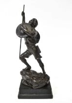 A bronzed spelter figure of a boy scout on a rocky outcrop, mounted on an ebonised plinth base,