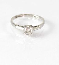 An 18ct white gold solitaire diamond ring, the stone within a square claw mount, stamped '18ct',