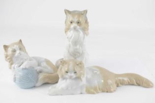 NAO; three porcelain cat figures, height of tallest 18cm (3).