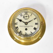 KELVIN WHITE & HUTTON, LONDON; a brass cased porthole clock, the white enamelled dial set with Roman